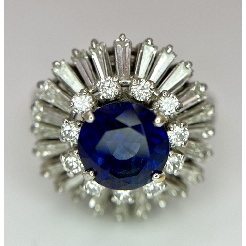 15 - A Gorgeous Sapphire and Diamond Platinum Ring. A deep blue 2.88ct round cut sapphire with a double h... 