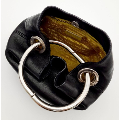 178 - A Prada Wrist Mini Leather Ring Handle Bag. Black nappa leather with maxi ring-shaped handle in silv... 