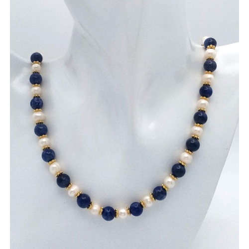 191 - A Lapis Lazuli and Cultured Pearl Matinee Necklace. 8mm beads and pearls. Gilded spacers and clasp. ... 