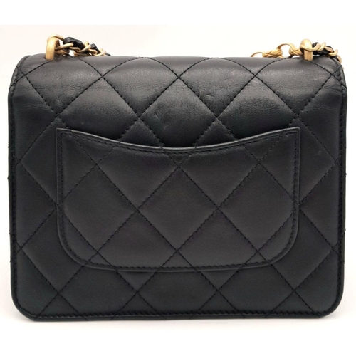 24 - A Chanel Black Mini Flap Bag. Quilted leather exterior with gold-toned hardware, pearl and onyx embe... 