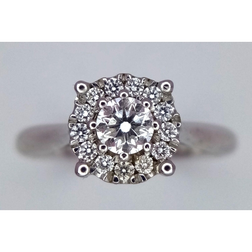 263 - A 9K White Gold Diamond Ring. 0.30ct brilliant round cut centre stone with diamond halo. Size I 1/2.... 