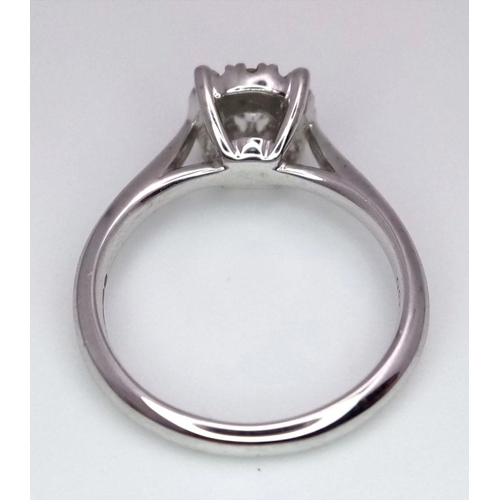 263 - A 9K White Gold Diamond Ring. 0.30ct brilliant round cut centre stone with diamond halo. Size I 1/2.... 