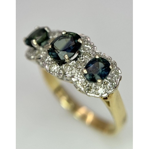 36 - An 18K Yellow Gold (tested) Sapphire and Diamond Ring. Three oval cut sapphires with a twenty-four d... 