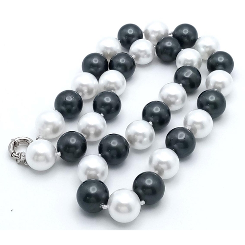 367 - A Fashionable Black and White South Sea Pearl Shell Beaded Necklace. Large 14mm beads. 44cm necklace... 