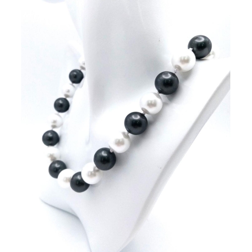 367 - A Fashionable Black and White South Sea Pearl Shell Beaded Necklace. Large 14mm beads. 44cm necklace... 