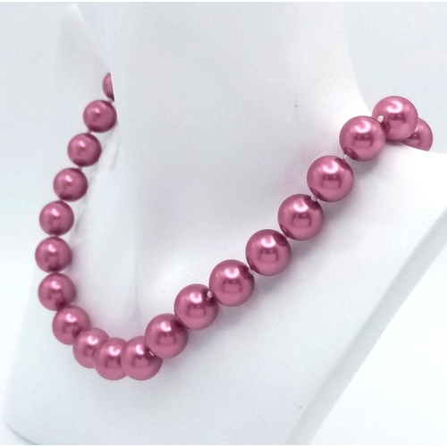 585 - A Hot Pink South Sea Pearl Shell Beaded Necklace with Heart Clasp. 12mm beads. 42cm necklace length.