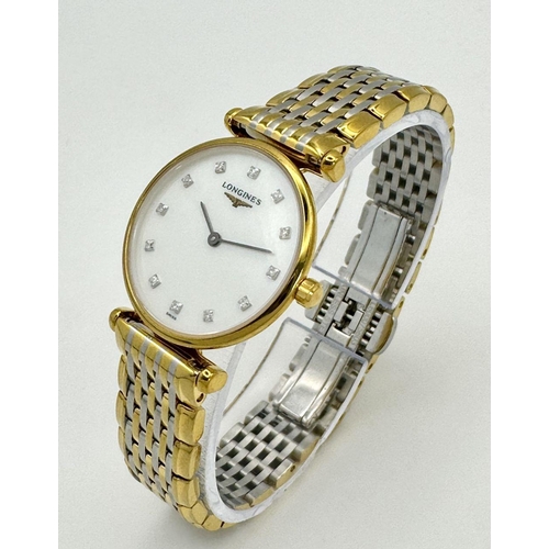 74 - A LADIES LONGINE BI-METAL WATCH WITH DIAMOND NUMERALS ON A MOTHER OF PEARL DIAL, MANUAL MOVEMENT IN ... 