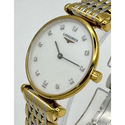 74 - A LADIES LONGINE BI-METAL WATCH WITH DIAMOND NUMERALS ON A MOTHER OF PEARL DIAL, MANUAL MOVEMENT IN ... 