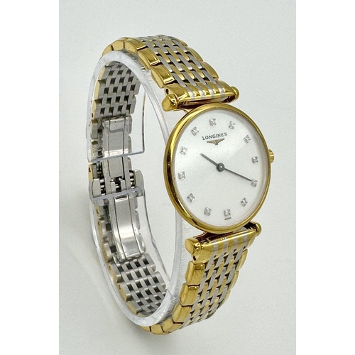 74 - A LADIES LONGINE BI-METAL WATCH WITH DIAMOND NUMERALS ON A MOTHER OF PEARL DIAL, MANUAL MOVEMENT IN ... 