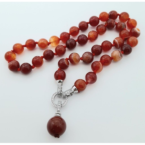 831 - A Luscious Red Striped Agate Beaded Necklace with Drop Pendant - 5cm. Beads - 10mm. Necklace length ... 