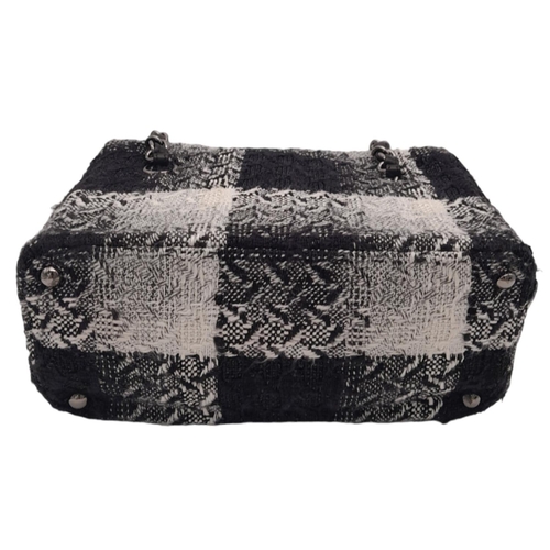 94 - A Chanel Black and White Vanity Tweed Handbag. Tweed exterior with silver-toned hardware, leather an... 