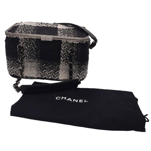 94 - A Chanel Black and White Vanity Tweed Handbag. Tweed exterior with silver-toned hardware, leather an... 