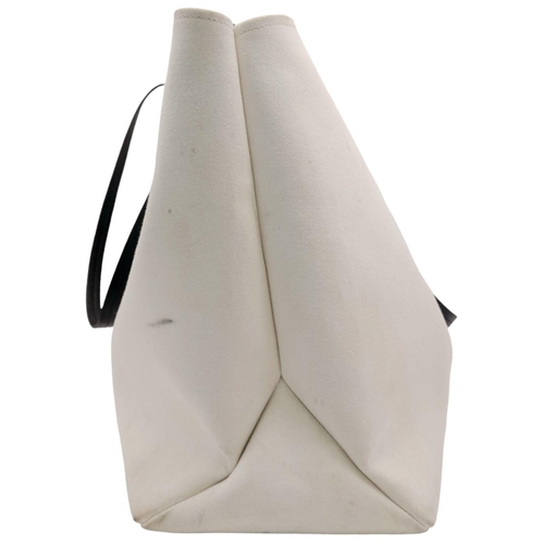 288 - A Prada Canapa Racing Logo Tote Bag. White Canvas exterior with a printed Prada logo on the front, f... 