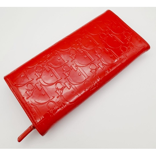 291 - A Christian Dior Red Patent Logo Embossed 'Ultimate' Continental Wallet. Leather exterior, silver-to... 