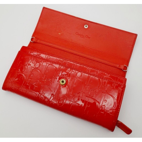 291 - A Christian Dior Red Patent Logo Embossed 'Ultimate' Continental Wallet. Leather exterior, silver-to... 