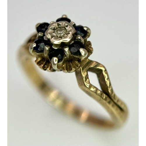 107 - an antique 9k rose gold ring with central diamond surrounded by sapphires .   2.4gms size K