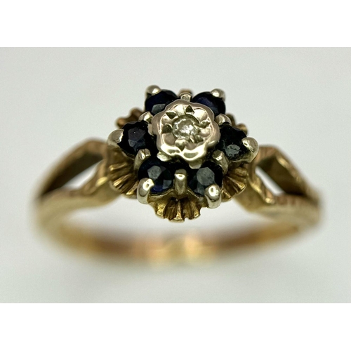 107 - an antique 9k rose gold ring with central diamond surrounded by sapphires .   2.4gms size K