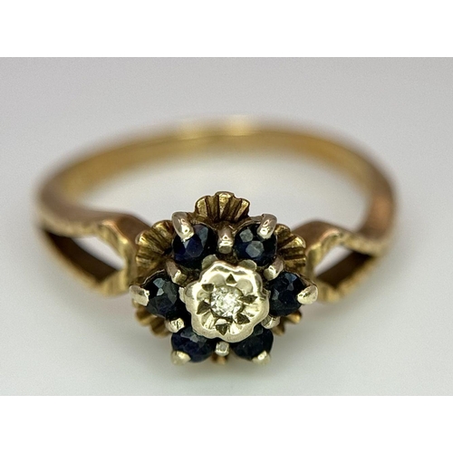 107 - an antique 9k rose gold ring with central diamond surrounded by sapphires .   2.4gms size K