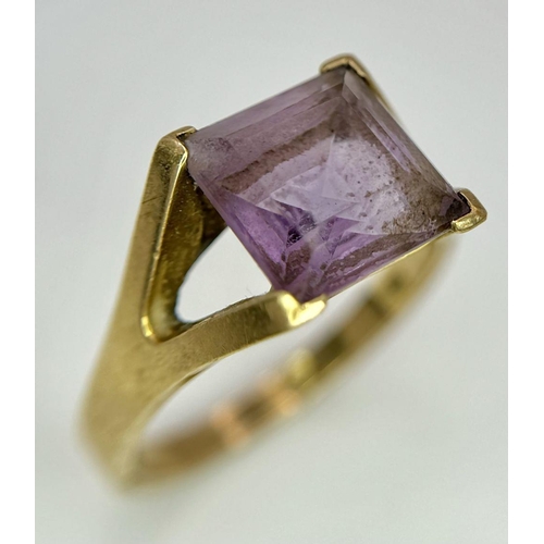 114 - A 9K GOLD DRESS RING WITH AMETHYST COLOURED SQUARE STONE .    5gms   size T