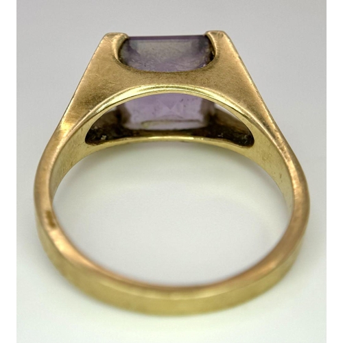 114 - A 9K GOLD DRESS RING WITH AMETHYST COLOURED SQUARE STONE .    5gms   size T