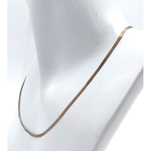 290 - A FLAT HERRINGBONE 9K GOLD NECKLACE .    1.7gms    40cms