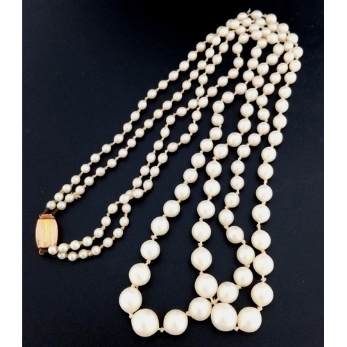 465 - A DOUBLE STRING OF GRADUATED PEARLS WITH A 9K GOLD CLASP.   28.9gms