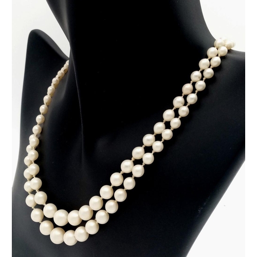 465 - A DOUBLE STRING OF GRADUATED PEARLS WITH A 9K GOLD CLASP.   28.9gms