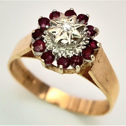 521 - A 9K YELLOW GOLD DIAMOND & RUBY RING. 2.9G. SIZE P.