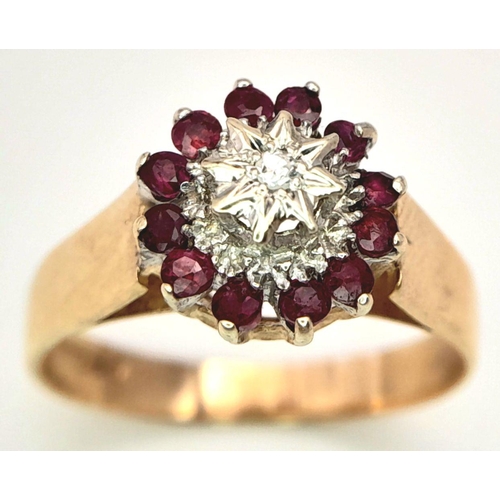 521 - A 9K YELLOW GOLD DIAMOND & RUBY RING. 2.9G. SIZE P.