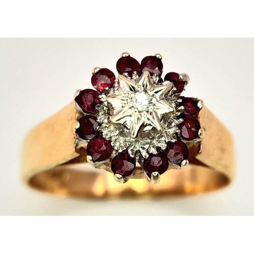 521 - A 9K YELLOW GOLD DIAMOND & RUBY RING. 2.9G. SIZE P.