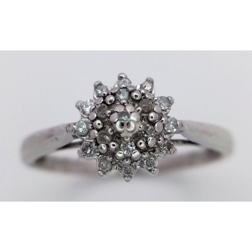 551 - A 9K WHITE GOLD DIAMOND CLUSTER RING - 2G. SIZE P