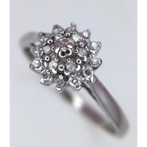 551 - A 9K WHITE GOLD DIAMOND CLUSTER RING - 2G. SIZE P