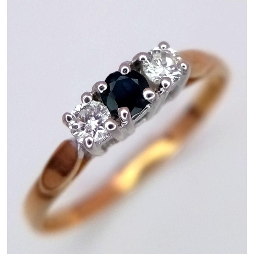 713 - A 9K YELLOW GOLD DIAMOND & SAPPHIRE 3 STONE RING. 1.2G. SIZE L