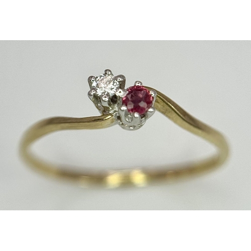 737 - A 9K YELLOW GOLD DIAMOND & RUBY 2 STONE TWIST RING. 0.9G. SIZE O.