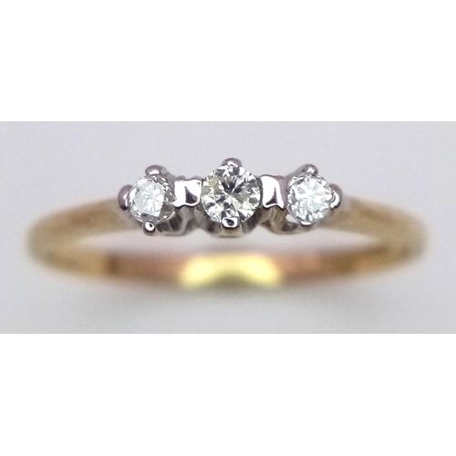 772 - A 9K YELLOW GOLD 3 STONE DIAMOND RING - 1.1G. SIZE L.