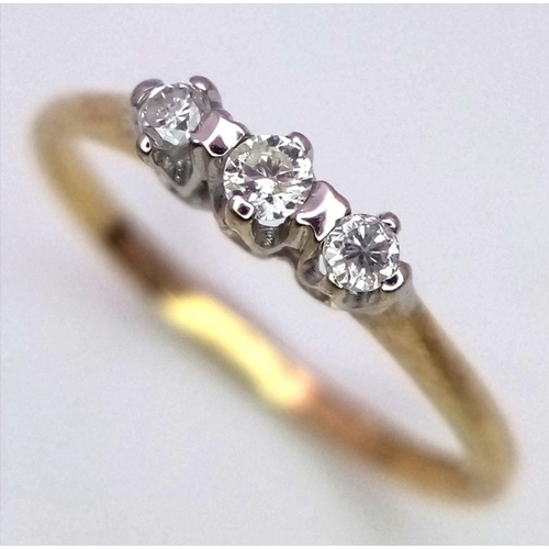 772 - A 9K YELLOW GOLD 3 STONE DIAMOND RING - 1.1G. SIZE L.