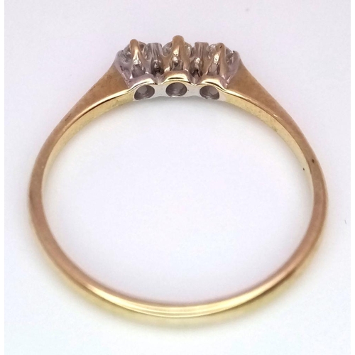 772 - A 9K YELLOW GOLD 3 STONE DIAMOND RING - 1.1G. SIZE L.