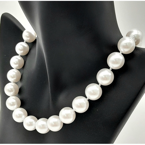 1259 - A Bright White South Sea Pearl Shell Bead Necklace. 14mm beads. 40cm. Gilded clasp.