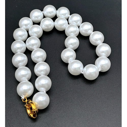 1259 - A Bright White South Sea Pearl Shell Bead Necklace. 14mm beads. 40cm. Gilded clasp.