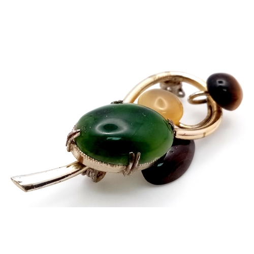 1441 - A Magical, Music Note Styled Multi-Gemstone Brooch. Jade, tigers eye, moonstone and agate hit the ri... 