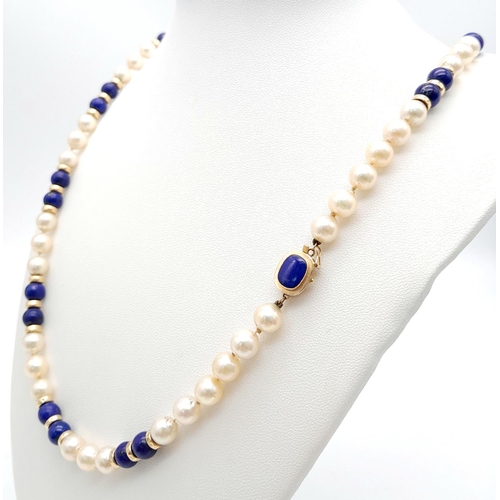 838 - A Lapis and Pearl Necklace with 14K Gold Spacers and Clasp. 
68cm