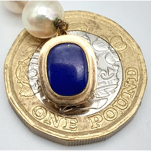 838 - A Lapis and Pearl Necklace with 14K Gold Spacers and Clasp. 
68cm