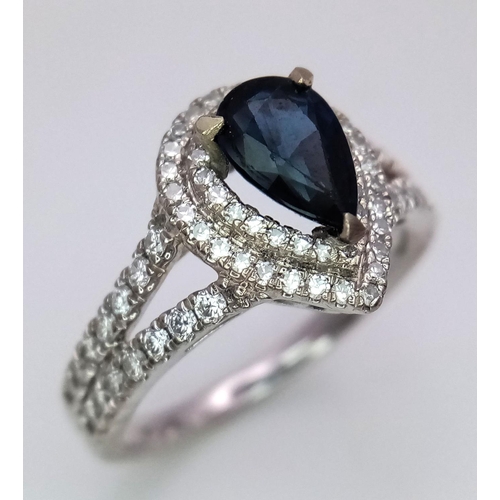 844 - An 18K White Gold Sapphire and Diamond Ring. Teardrop sapphire with a 0.50ctw diamond surround. Size... 