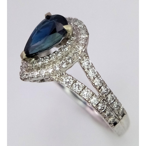 844 - An 18K White Gold Sapphire and Diamond Ring. Teardrop sapphire with a 0.50ctw diamond surround. Size... 