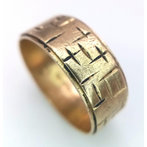 879 - A Vintage 9K Yellow Gold Band Ring. Geometric decoration. 7mm width. Size O. 4.3g weight.