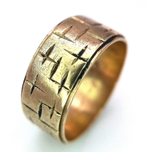 879 - A Vintage 9K Yellow Gold Band Ring. Geometric decoration. 7mm width. Size O. 4.3g weight.