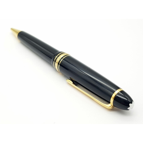 823 - A Montblanc Meisterstruck Black and Gold Tone Ball Point Pen. 15cm. Ref: 016938