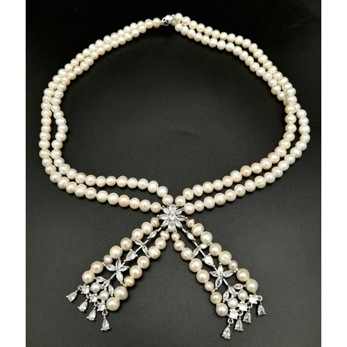 196 - A fabulously designed pearl necklace with cubic zirconia. The genuine natural white pearls are of ex... 