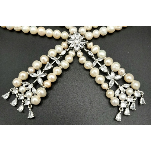 196 - A fabulously designed pearl necklace with cubic zirconia. The genuine natural white pearls are of ex... 