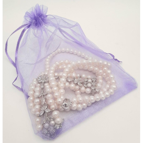 196 - A fabulously designed pearl necklace with cubic zirconia. The genuine natural white pearls are of ex... 